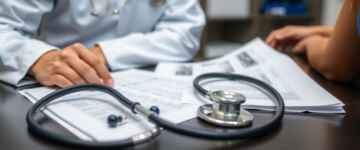 Physician reviewing patient records in an office setting.