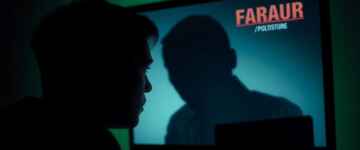 Person fearful of being watched on computer screen.